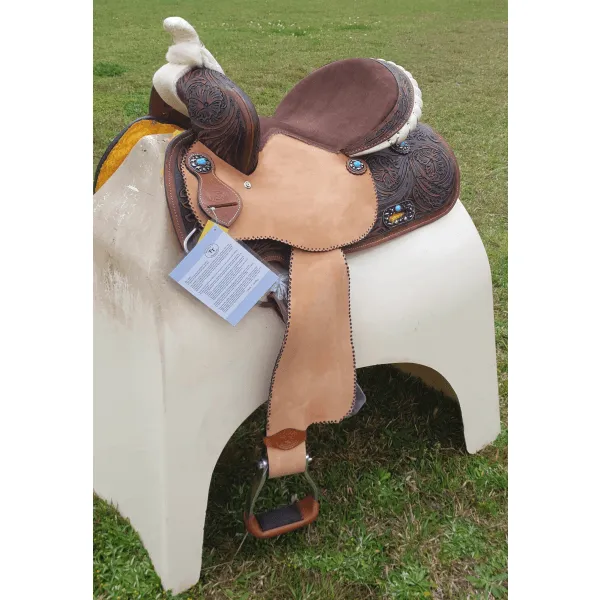 14", 15", 16" Double T barrel saddle with silver laced tan rawhide cantle, dot border on rough out fenders and jockeys.