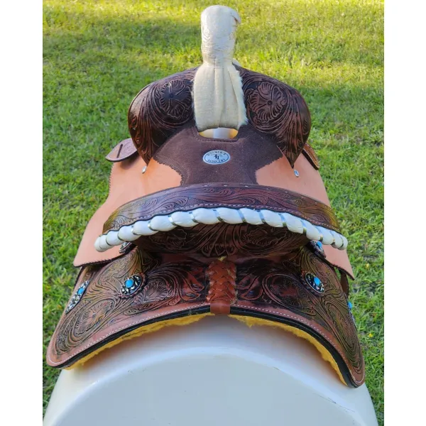 14", 15", 16" Double T barrel saddle with silver laced tan rawhide cantle, dot border on rough out fenders and jockeys.